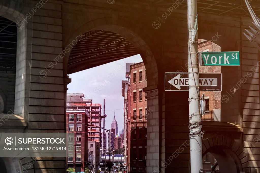 USA, New York City, Brooklyn Bridge pillars, Empire State Building in background