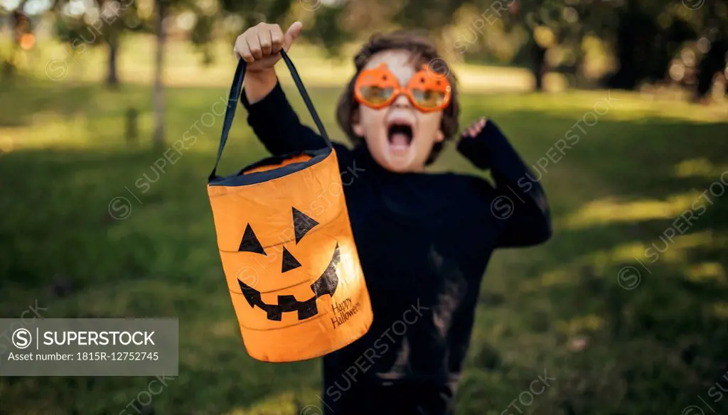 Masquerade little girl holding halloween lantern