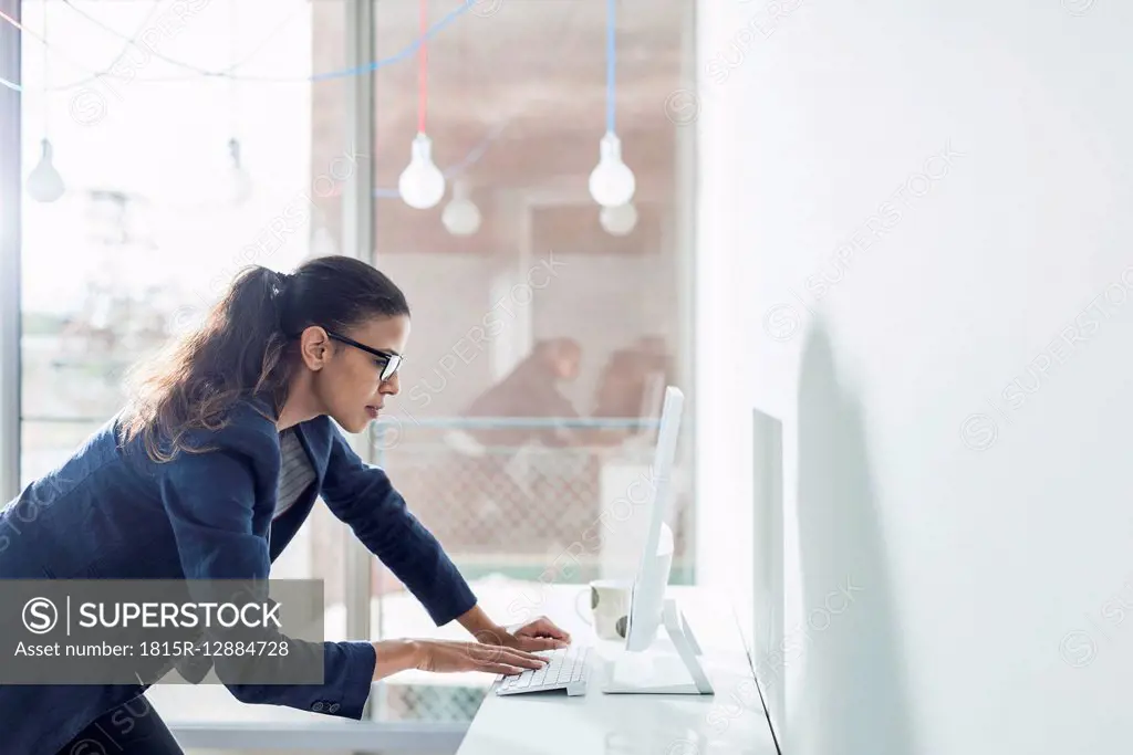 Young woman in office working on computer