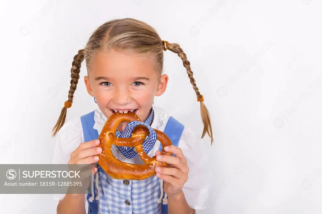 Portrait of little girl eating pretzel