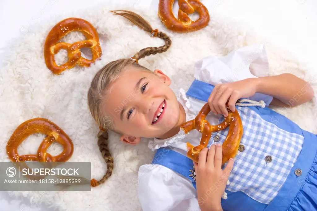 Portrait of happy little girl with pretzels