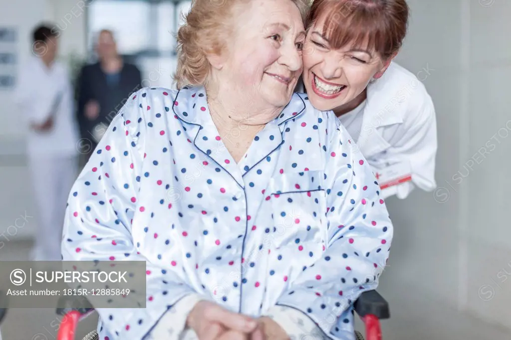 Doctor caring for elderly patient in wheelchair