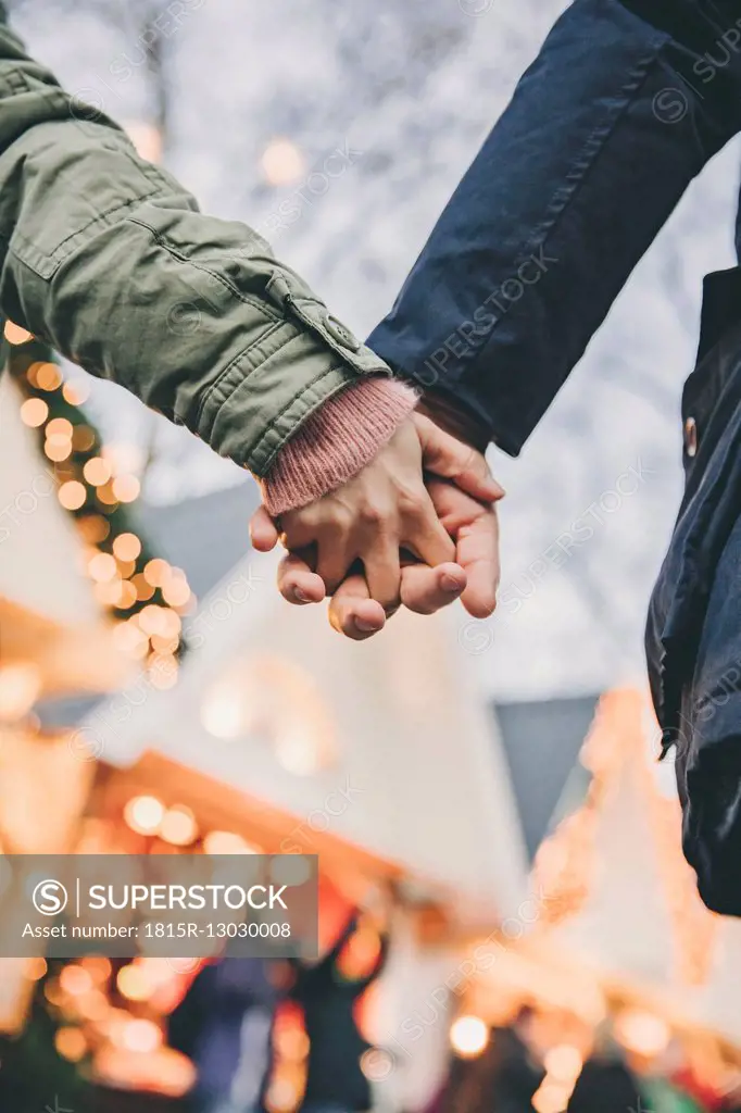 Close-up of couple holding hands on the Christmas Market