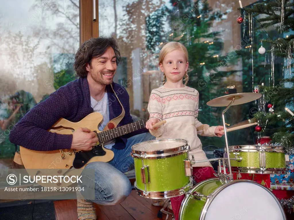 Father and daughter playing music on Christmas Eve