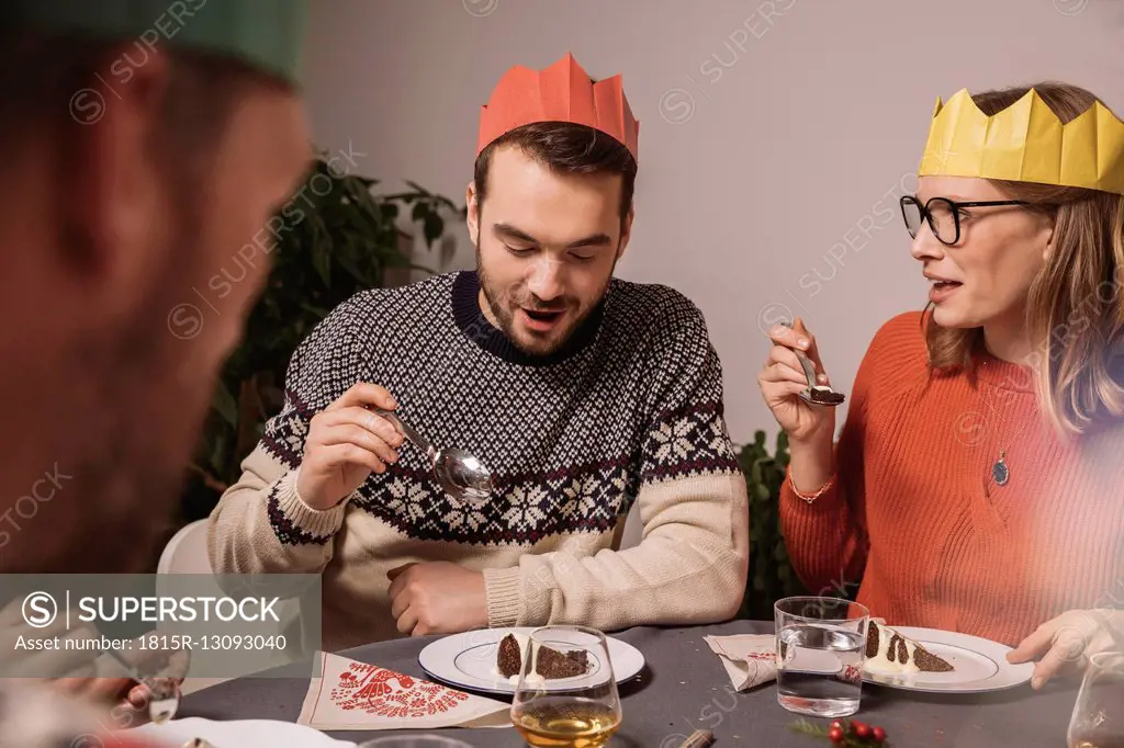 Family members talking while having Christmas pudding