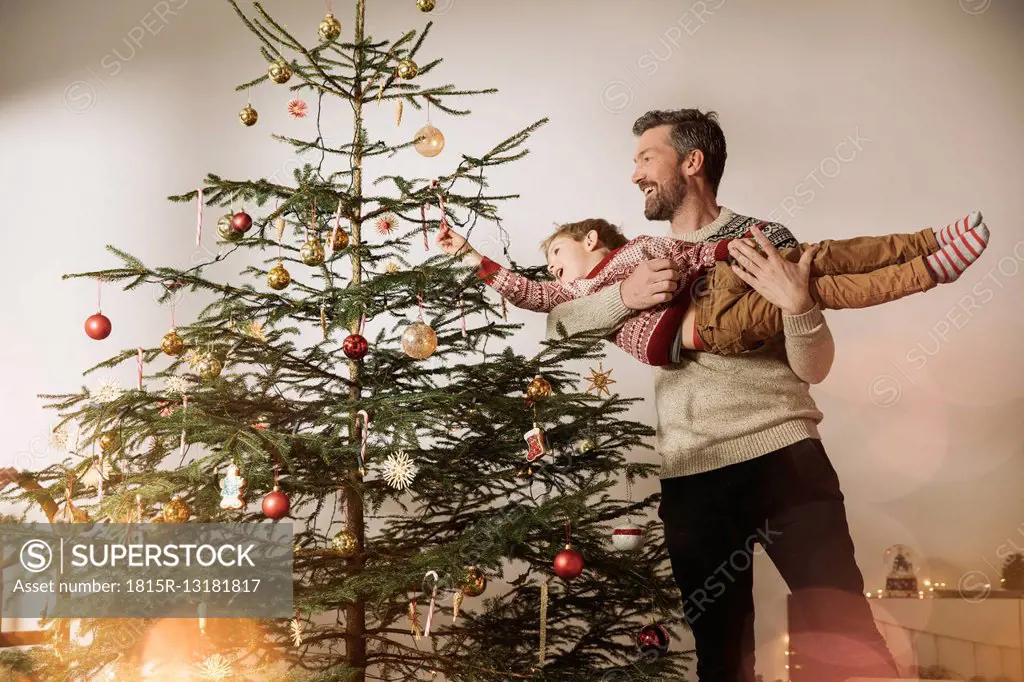 Father and son decorating Christmas tree