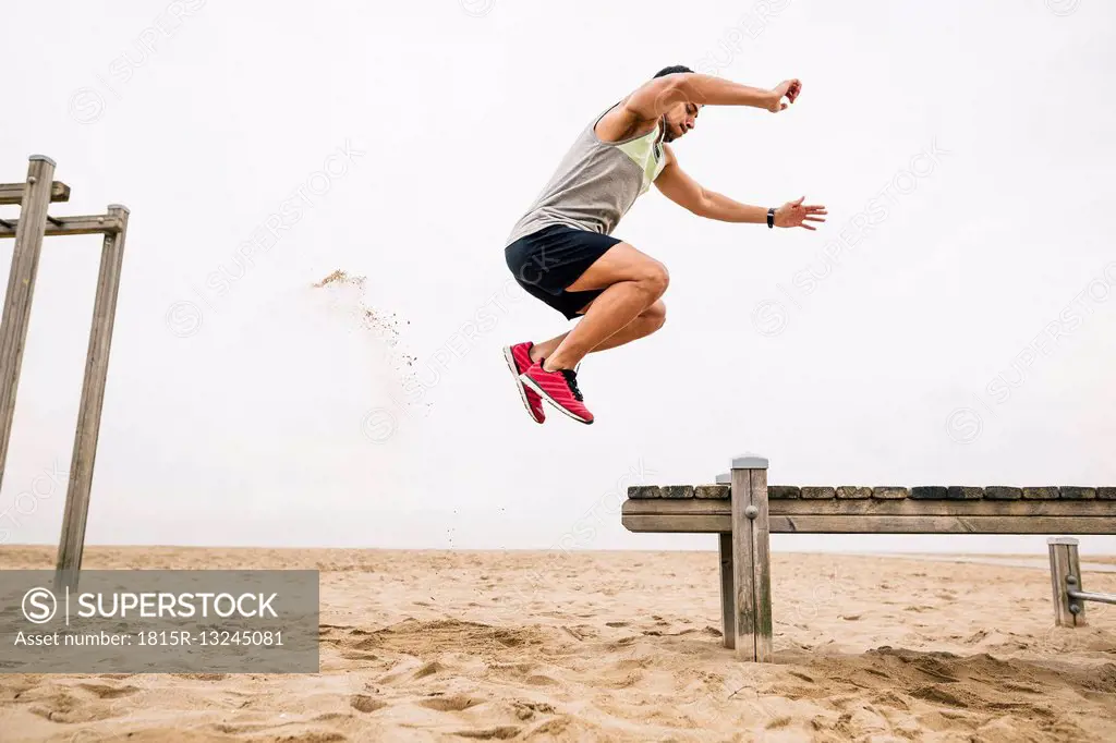 Young man jumping on the beach