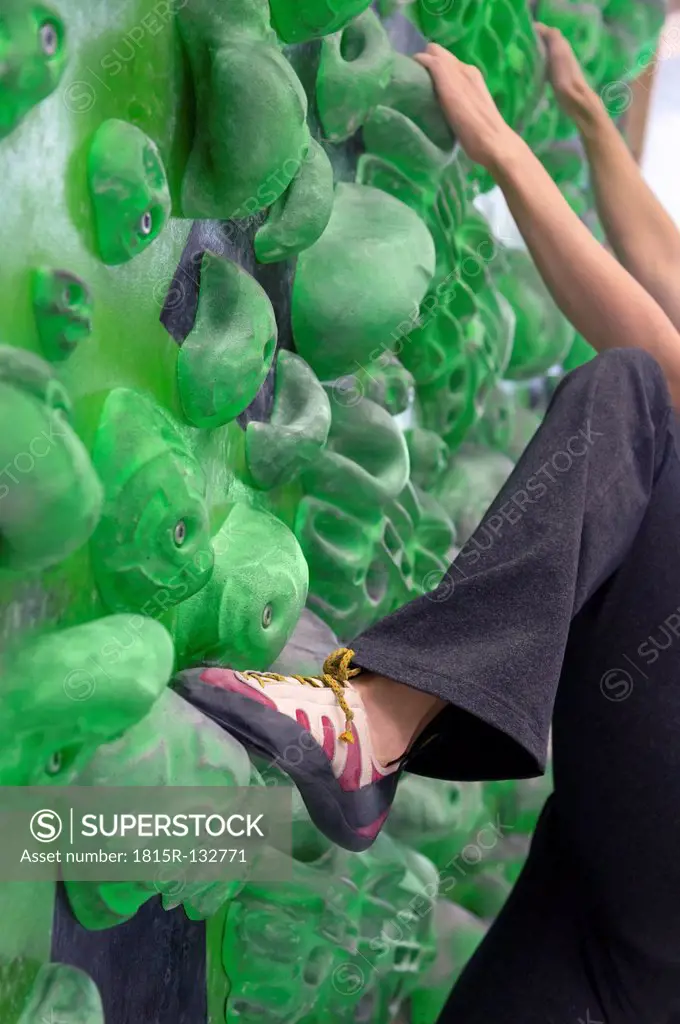 Germany, Bavaria, Munich, Young woman bouldering