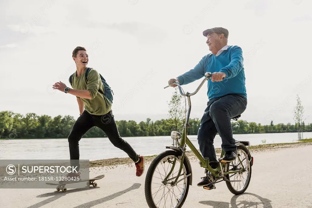 Grandfather and grandson having fun together at riverside