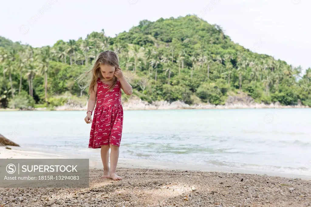 Thailand, girl in red dress on beach