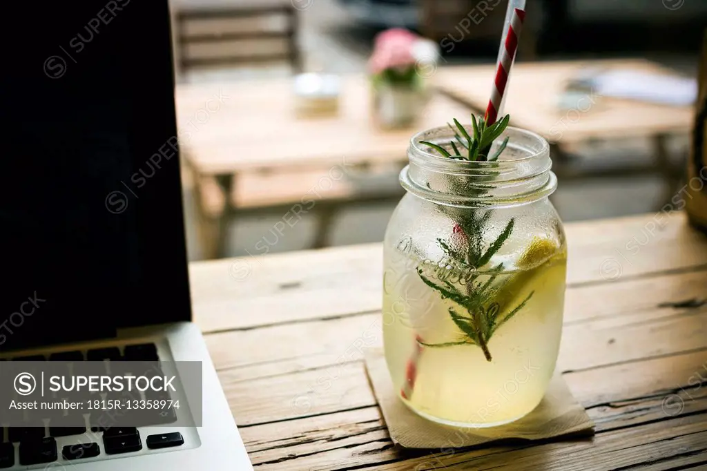 Homemade lemonade and laptop on table in a cafe