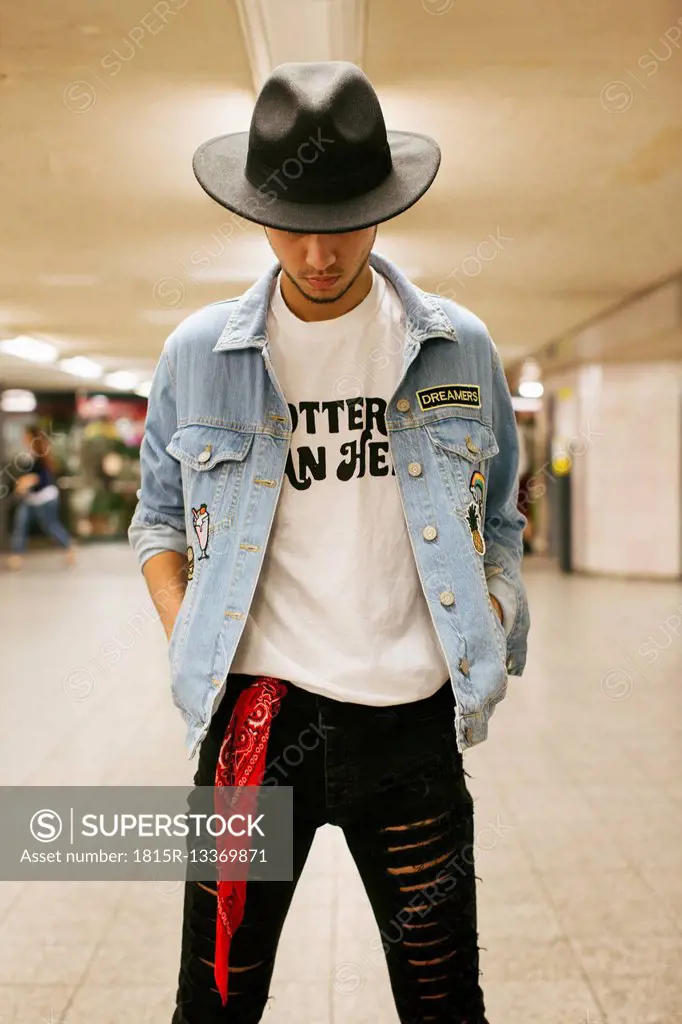 Fashionable young man wearing hat and jeans jacket