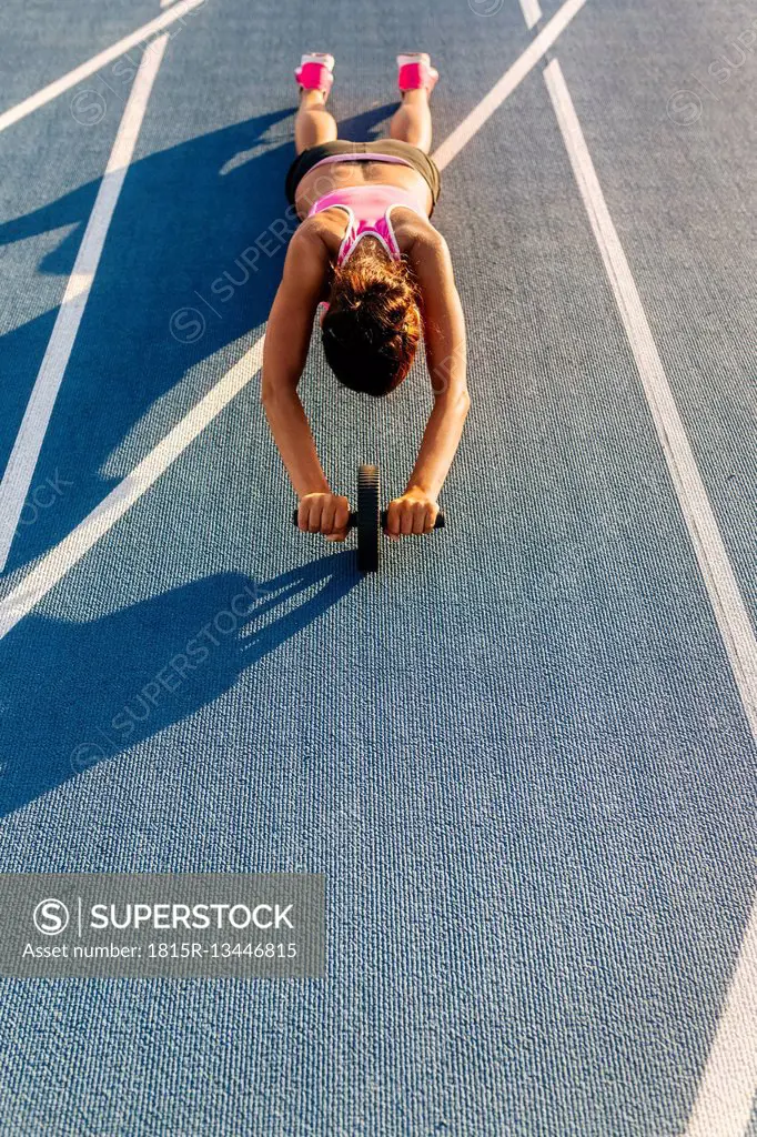 Female athlete doing strength training with a roller