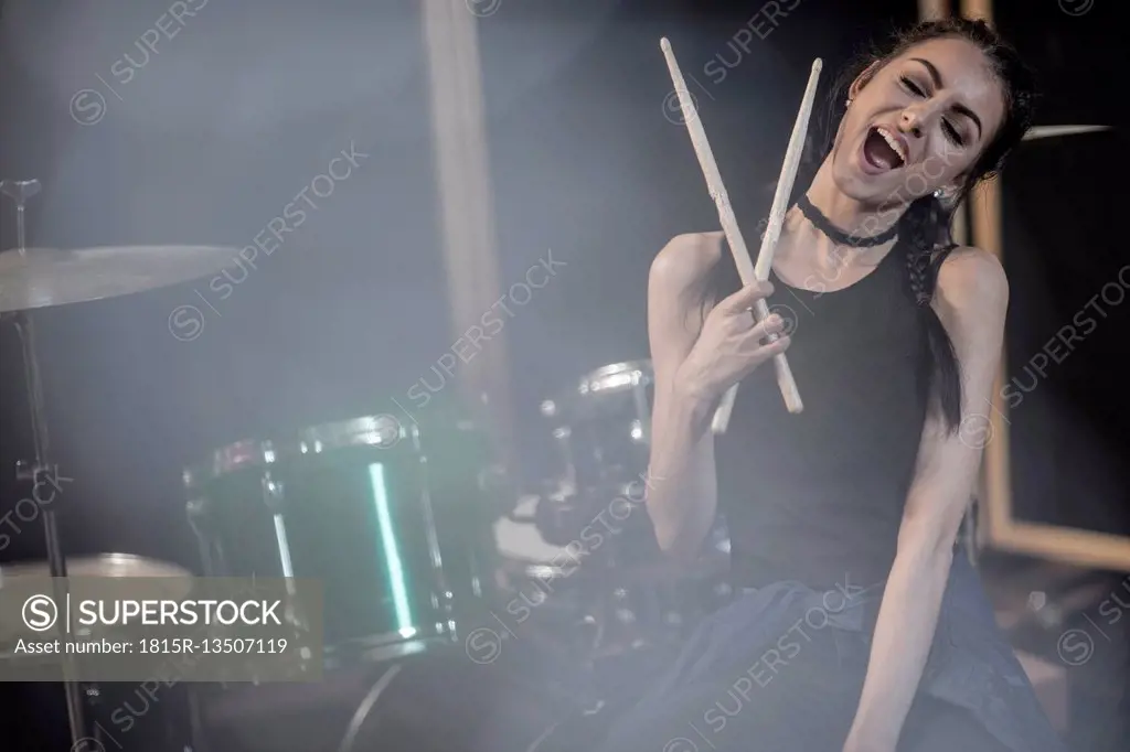 Female rock drummer at recording studio