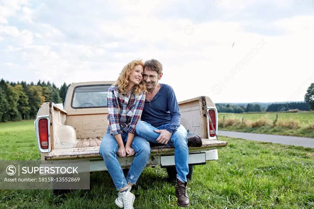 Couple sitting on pick up truck