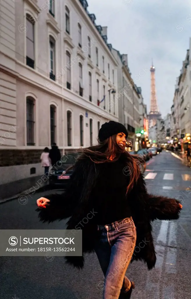 France, Paris, young woman on the street with the Eiffel Tower in the background