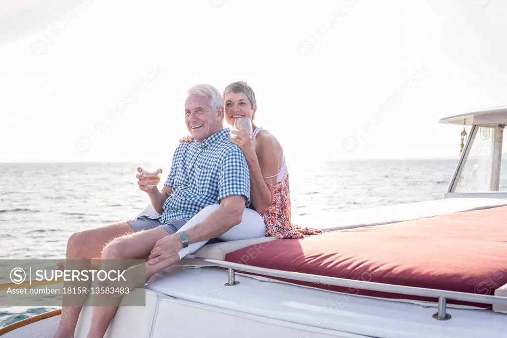 Happy couple having a drink on a boat trip