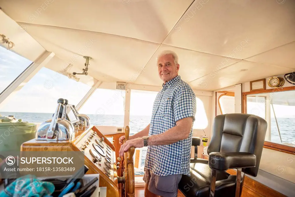 Confident senior man steering a boat