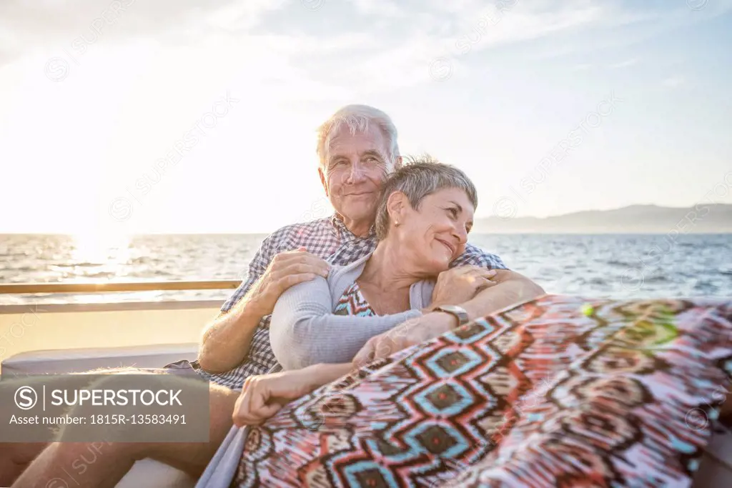 Affectionate couple on a boat trip at sunset