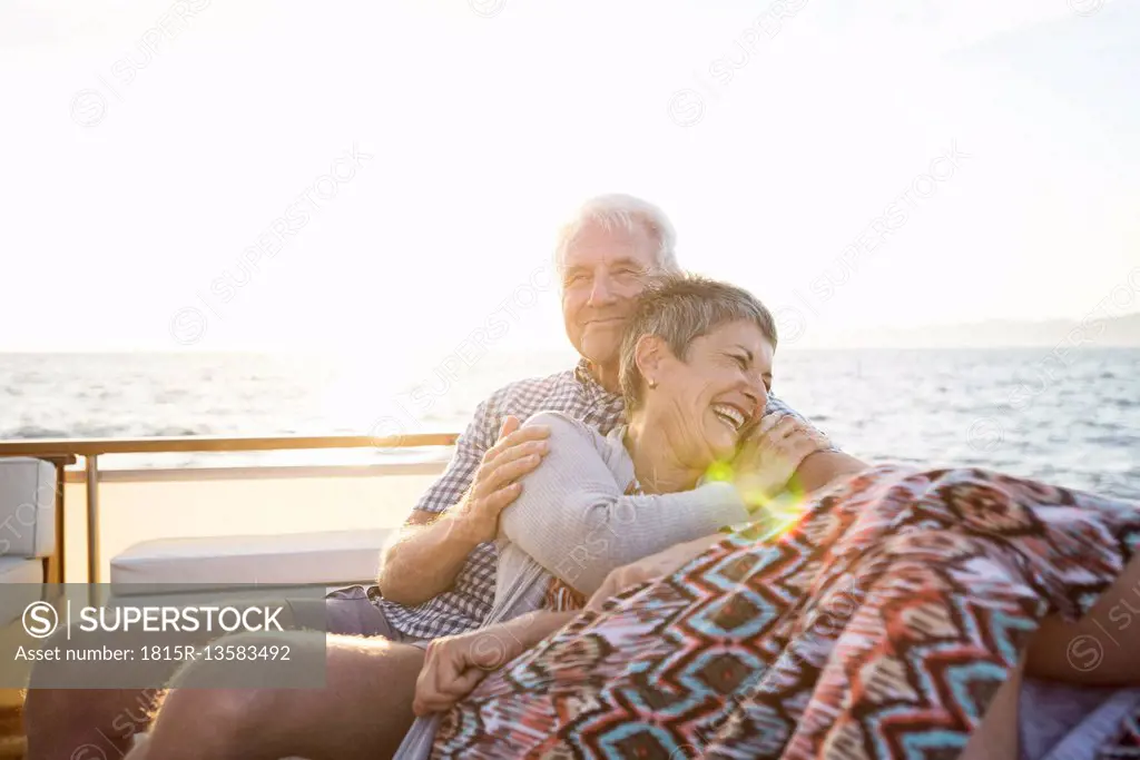 Affectionate couple on a boat trip at sunset