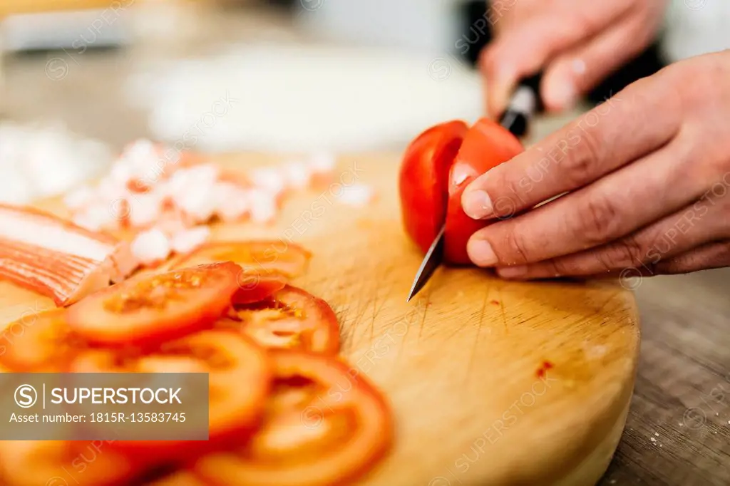 Slicing tomatoes in kitchen