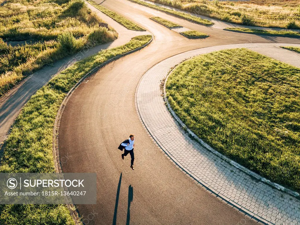 Businessman running in roundabout