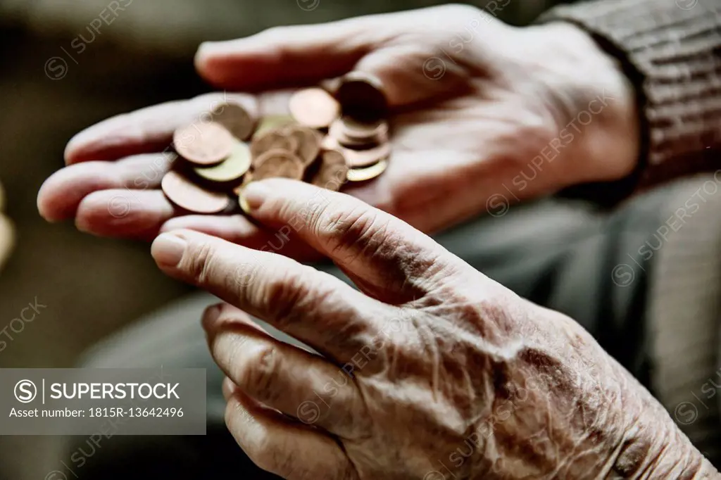 Senior woman's hands with coins