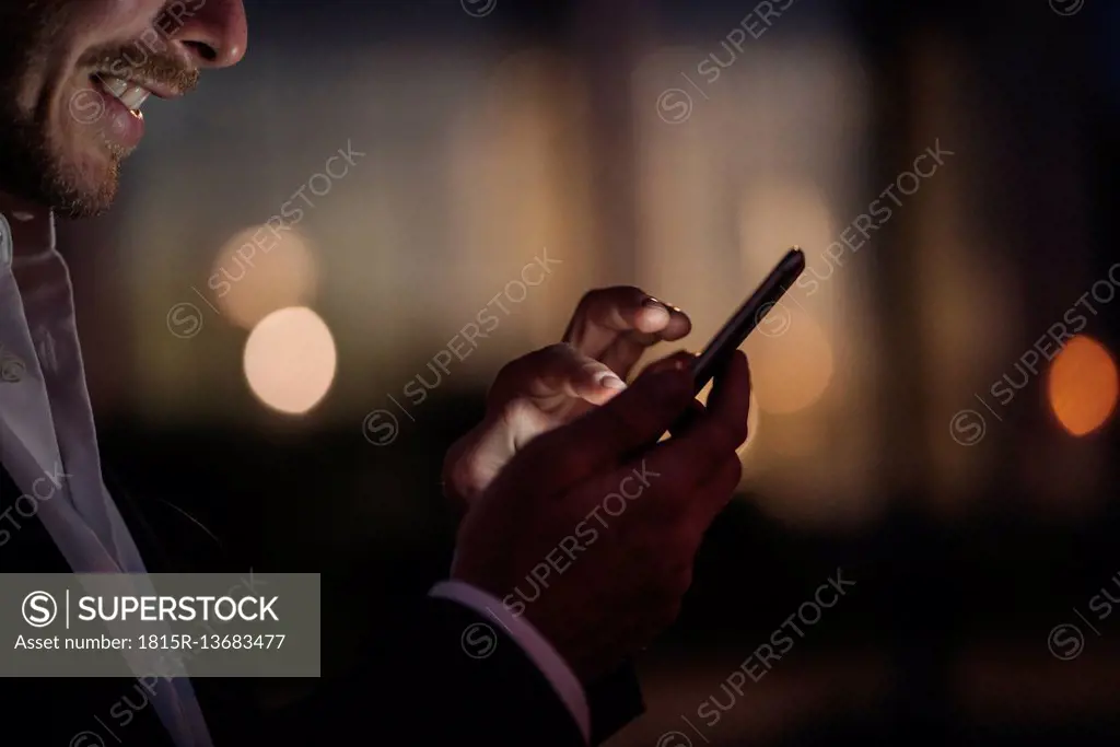 Close-up of businessman text messaging