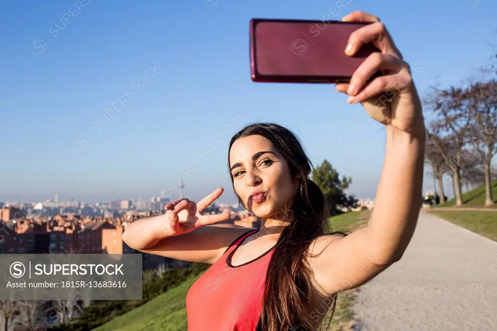 Female athlete posing for a selfie with her phone