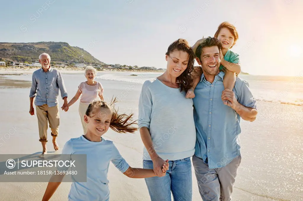 South Africa, Cape Town, three generations family strolling on the beach