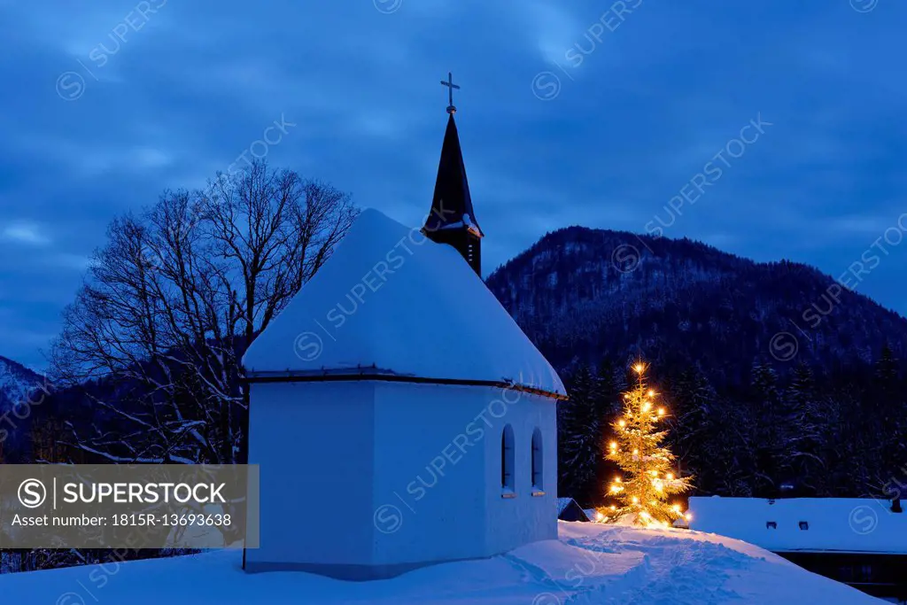 Germany, Lenggries, chapel and lighted christmas tree