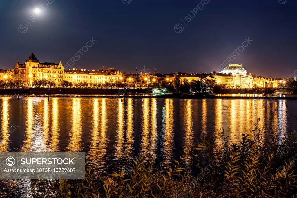 Czechia, Prague, view to National theatre with Vltava in the foreground at night