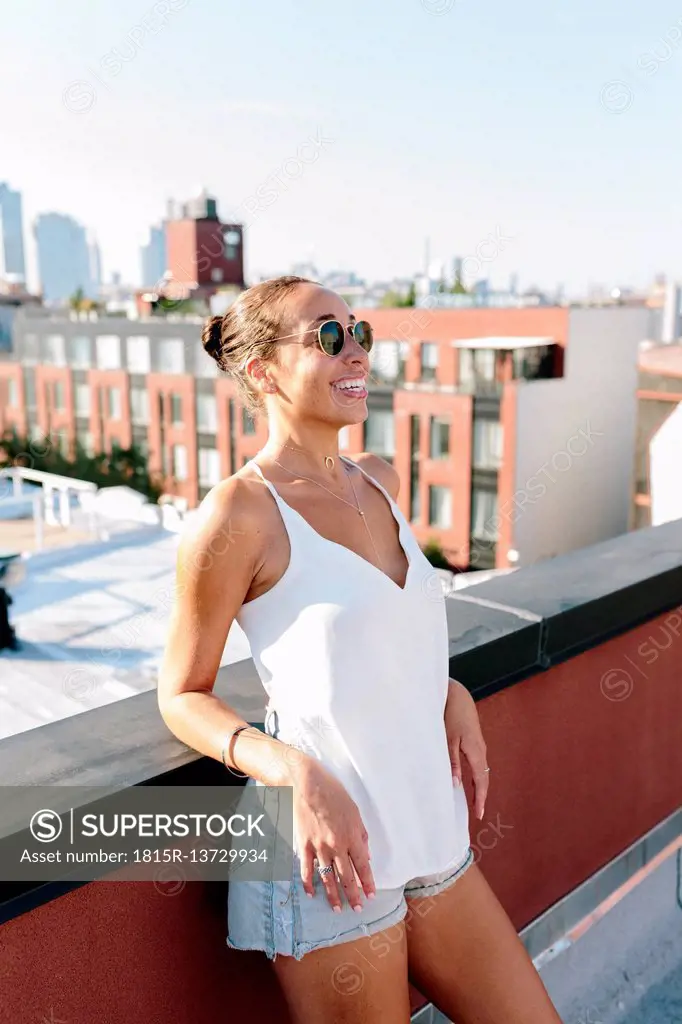 Relaxed woman standing on rooftop in Brooklyn