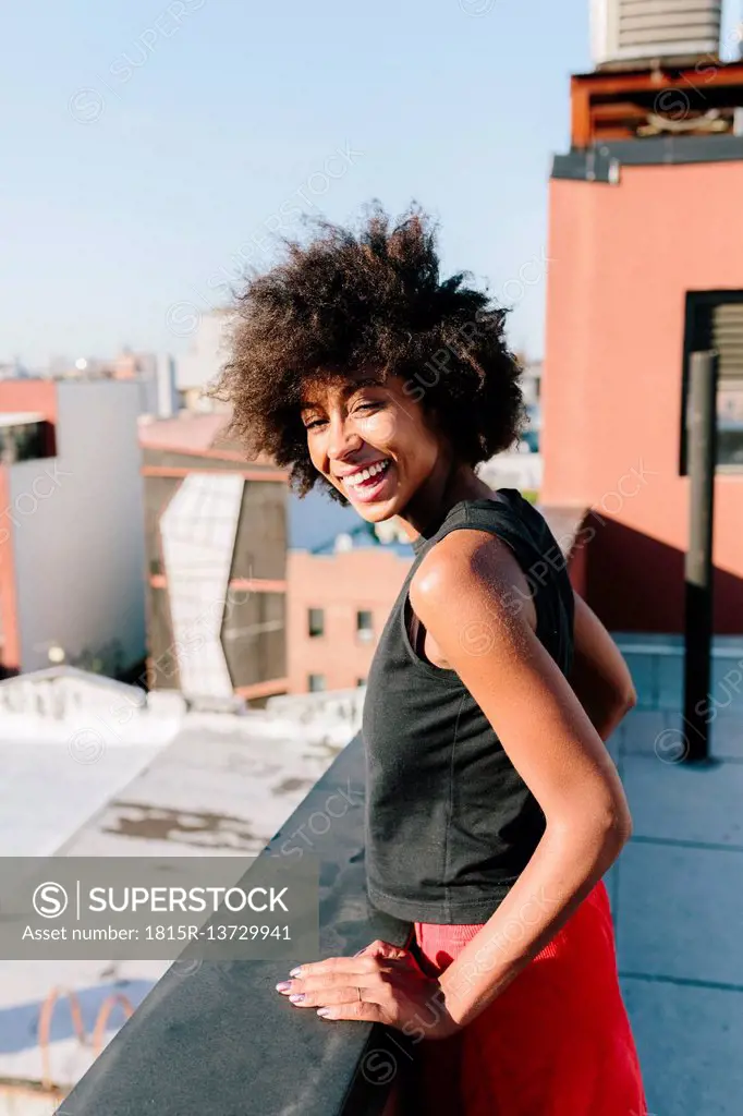 Relaxed woman standing on rooftop in Brooklyn