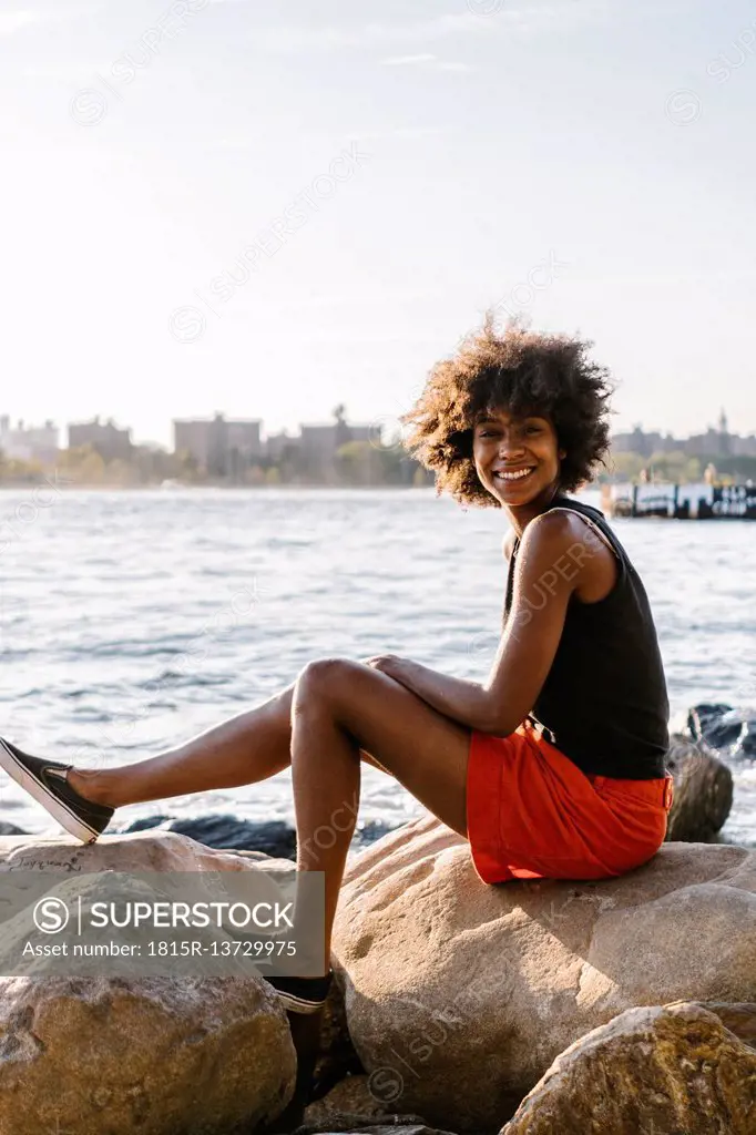 Young woman in Brooklyn sitting at East River