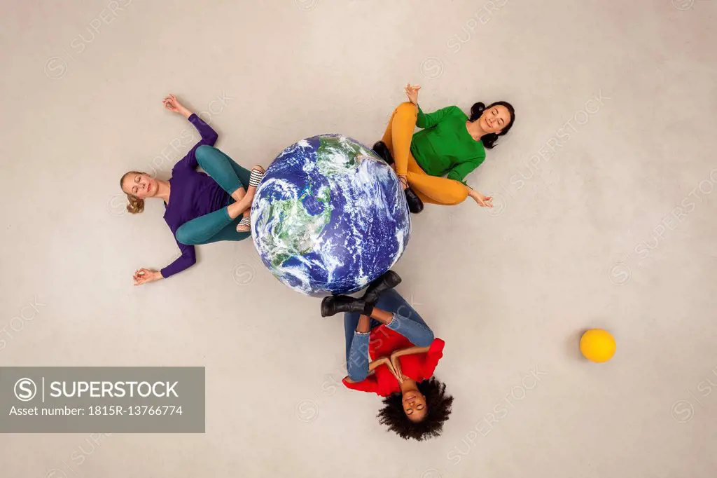 Three women meditating for the world