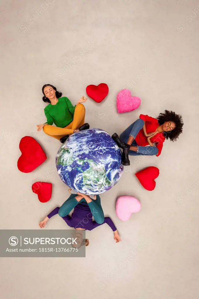 Three women meditating for the world