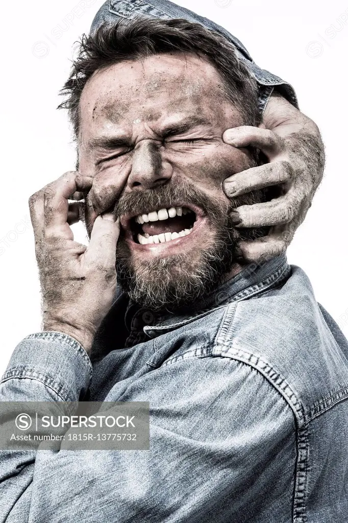 Portrait of screaming man with dirty face