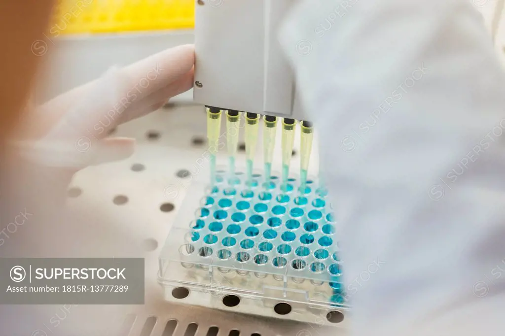 Close-up of laboratory technician pipetting in lab