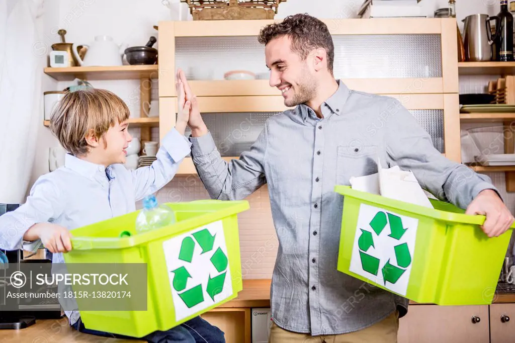 Father and son at home with waste boxes