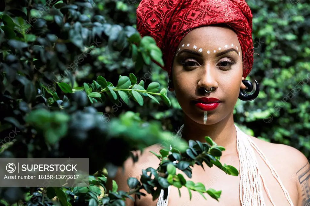 Portrait of young woman with piercings wearing traditional Brazilian headgear