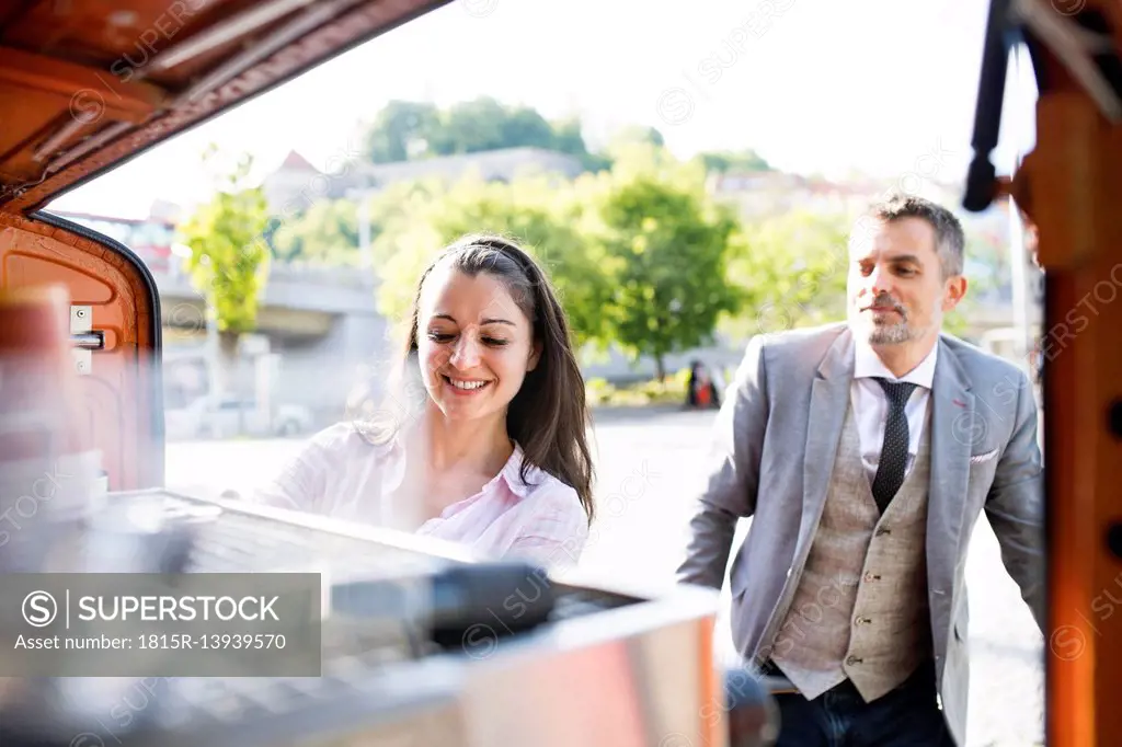 Businessman buying take away coffee on the street