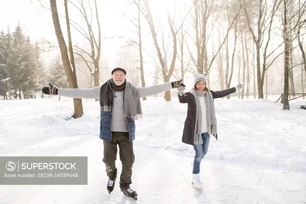 Happy senior couple ice skating