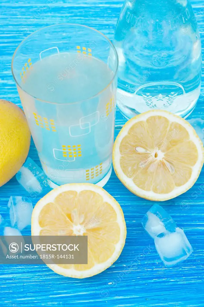 Germany, Baden Wuerttemberg, Lemonade juice on wooden table, close up