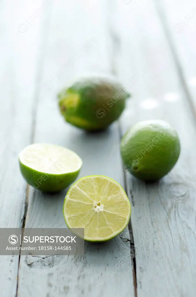 Limes on wooden table, close up