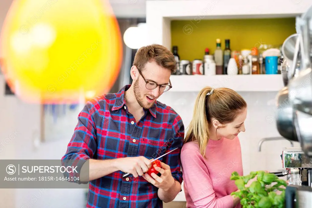 Young couple preparing healthy meal in kitchen