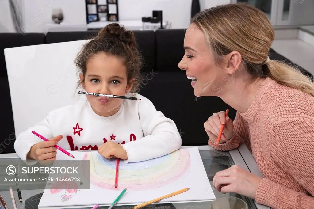 Mother and little daughter having fun at home