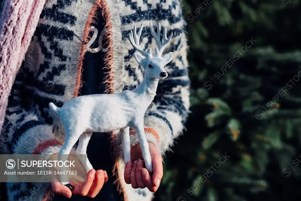 Little girl holding toy reindeer