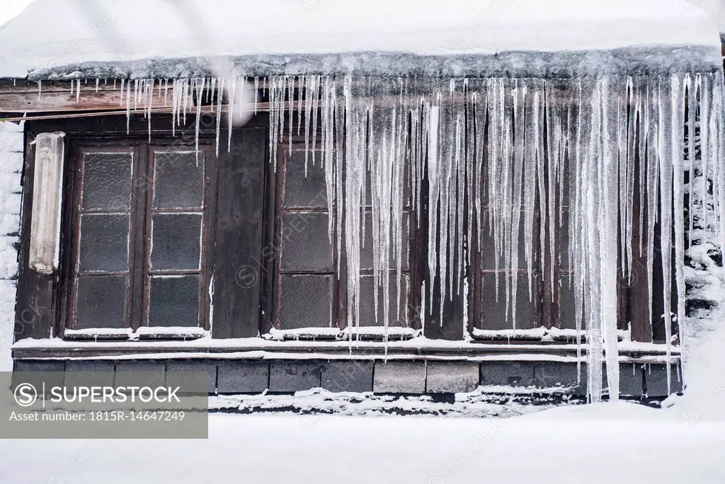 Icicles hanging down from a roof top in winter