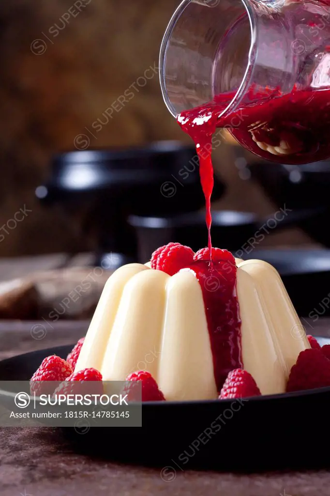 Custard with raspberries and raspberry sauce on plate
